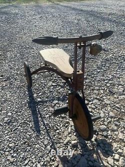 1920's Antique tricycle with wood seat and filled in wheels