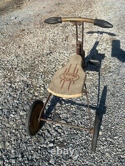 1920's Antique tricycle with wood seat and filled in wheels