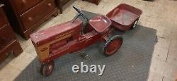 Vintage McCormick Farmall pedal tractor with trailer