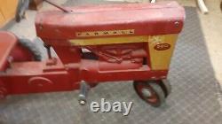 Vintage McCormick Farmall pedal tractor with trailer