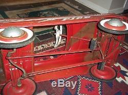 Vintage a red fire chief pedal car their is M initial on the wheel